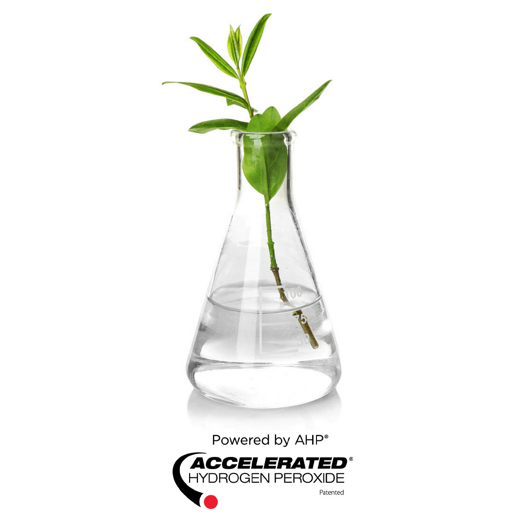 Plant in beaker with Accelerated Hydrogen Peroxide® and AHP® Logos